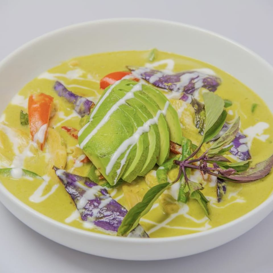 Sisters Asian Eatery's Thai green curry with avocado, purple eggplant, and red bell peppers.